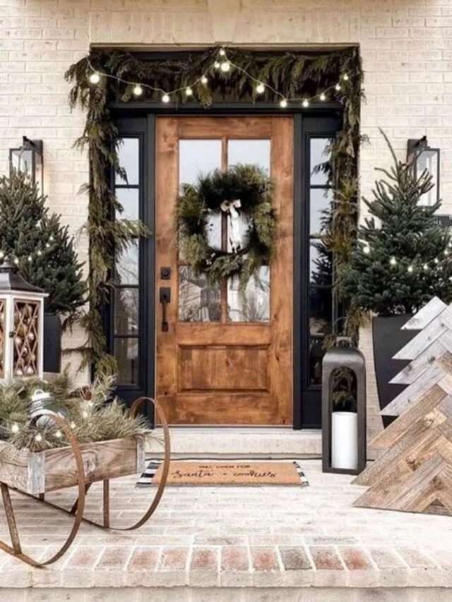 Front entryway with winter greenery and warm lighting.